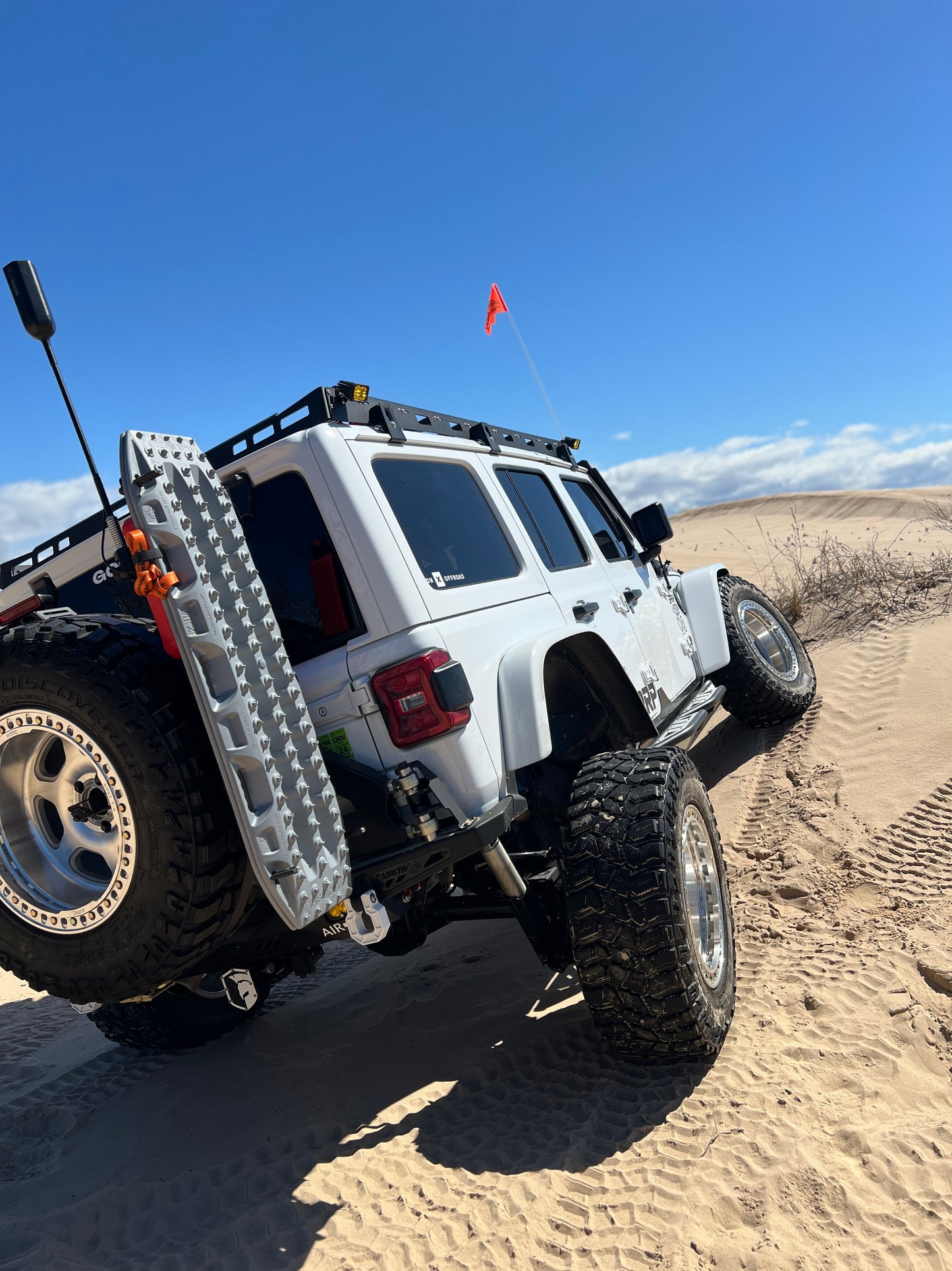 90° bracket for R90° bracket for weboost mounted to a recovery board mounting plate on the back of a Jeep